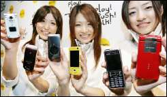 NTT DoCoMo employees unveil the company\'s new 3G handsets