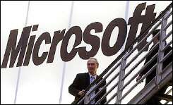 People walking past a giant Microsoft logo