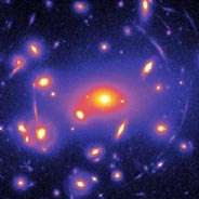 Gravitational lensing image of galaxies (yellow to red) and haloes from clumped dark matter (blue)