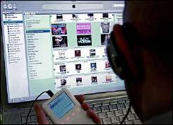 A man uses the iTunes Music Store to download music