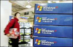 A customer walks near a display of Microsoft Windows XP software