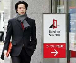 A pedestrian passes before the Livedoor Securities office