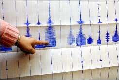 An official at a seismology center points to earthquake readings