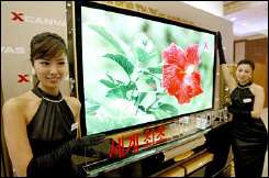 Models display a 71-inch plasma display panel television of LG Electronics