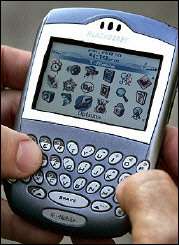 A businessman checks his Blackberry