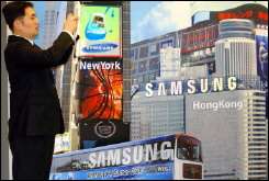 A South Korean in front of the advertisement board of Samsung Electronics in Seoul