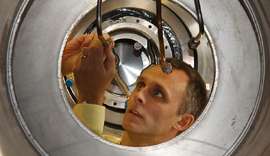 Philip Harris inspects the liquid helium supply pipes on the neutron Electric Dipole Moment cryostat