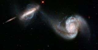 Hubble sees the graceful dance of 2 interacting galaxies