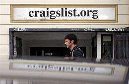 A man walks past the office of online site Craigslist in San Francisco