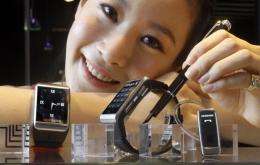 A model displays what Samsung claims to be the world's slimmest watch-shaped mobile phone