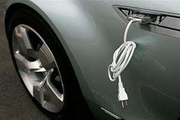 An electric cable is attached to the side of a car