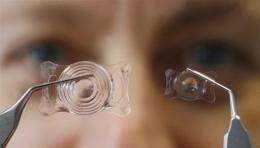 An employee of the S & V Technologies company shows adherent lenses for a horse (left) and a dog