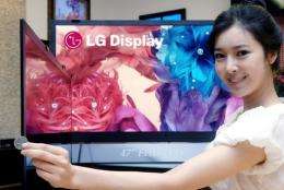 A promoter shows off  liquid crystal display (LCD) television panels in Seoul earlier this year
