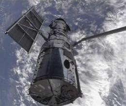 Astronauts grab Hubble, prepare for tough repairs (AP)