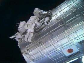 Astronauts work on The International Space Station's Japanese Kibo module
