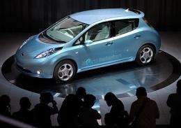 Photographers take pictures of the new Japanese Nissan Motor's electric vehicle called "Leaf"