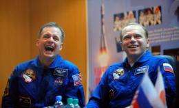 US astronaut Timothy Creamer (L) and Russian cosmonaut Oleg Kotov give a press conference
