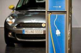 An electric car of the model Mini type E standing behind an electric charging station in Berlin