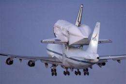 Space shuttle Discovery begins flight to Florida (AP)