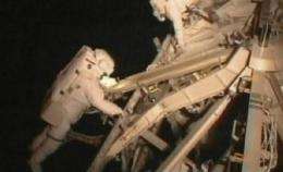 Astronauts get extra work done in 1st spacewalk (AP)