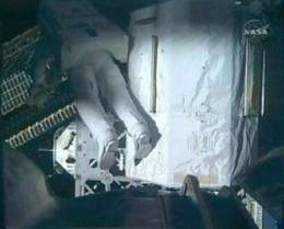 Astronauts take spacewalk No. 3 after suit snag (AP)