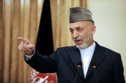 Afghan President Hamid Karzai calls on a reporter at a press conference