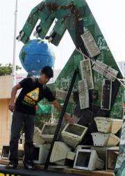 A Greenpeace stands by an installation made from hazardous e-waste in New Delhi