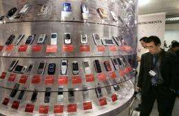 A man looks at mobile phones displayed in Cannes, southern France