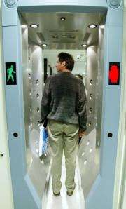 A man passes through a high-tech explosive-detection machine at John F. Kennedy airport in New York