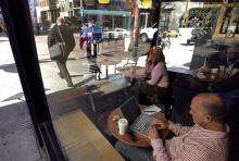 A man uses a wireless internet access at a Starbucks Coffee shop in San Francisco, California