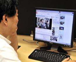 A man watches a video of Taro Aso