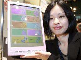 An employee of Japanese computer giant Fujitsu displays the company's mobile information terminal "FLEPia"