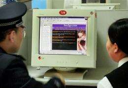 A policeman checks out a porn website at an Internet cafe in Beijing