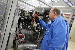 A technician of German automaker Volkswagen's adjusts a mini gas-fired power plant
