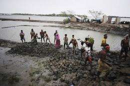 Bangladeshi villagers rebuild an embankment in Padmapukir on the outskirts of Satkhira