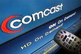 Comcast's 2Q profit soars 53 pct, tops estimates (AP)