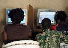 Customers browse the Internet in a cybercafe in Abidjan on August 11, 2009