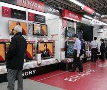Customers check Sony's Bravia LCD TVs at a shop in Tokyo