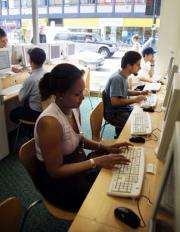 Customers surf the internet at a cyber cafe in London