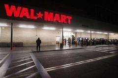 Early morning shoppers await the opening of a Wal-Mart store
