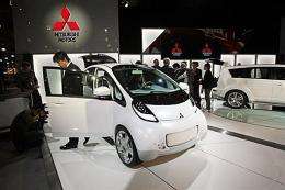 People inspect the Mitsubishi i-MiEv, a new electric microcar