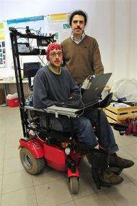 Professor Matteo Matteucci (R) and Ph.d student Bernardo Dal Seno (C), wearing a skullcap mounted with electrodes