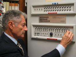 Scientist Leonard Kleinrock poses with the first Interface Message Processor