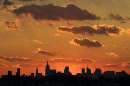 The sun sets behind the Manhattan skyline on December 11 in New York