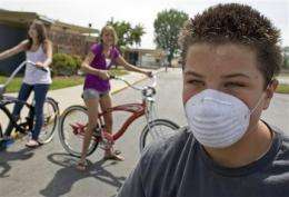 US no longer advising schools close for swine flu (AP)
