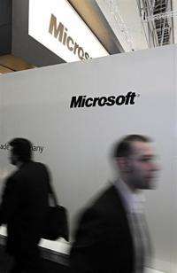 Visitors walk past the stand Microsoft at the world's biggest high-tech fair