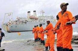 Workers haul part of a fibre optic cable onto the shore at the Kenyan port town of Mombasa