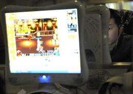 A chinese man plays online games at an internet cafe