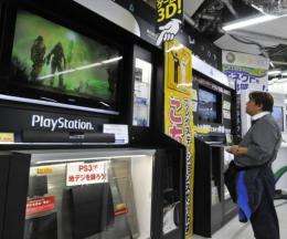 A customer watches a monitor of Sony's videogame PlayStation 3 at a Tokyo electric shop
