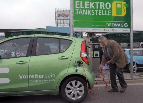 A man charges his electric car